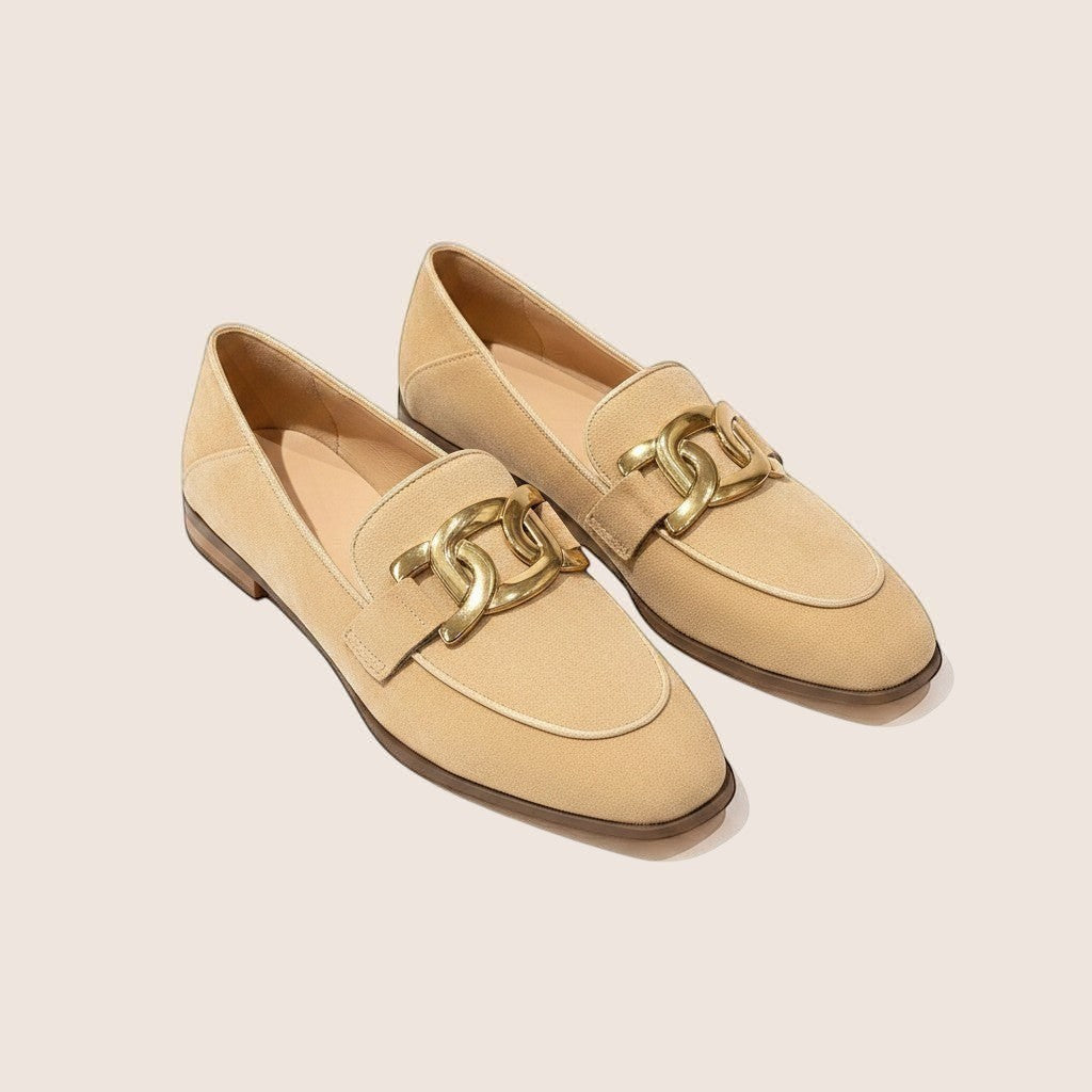 Norielle women's beige microfiber loafers with gold chain detail and thick heel.