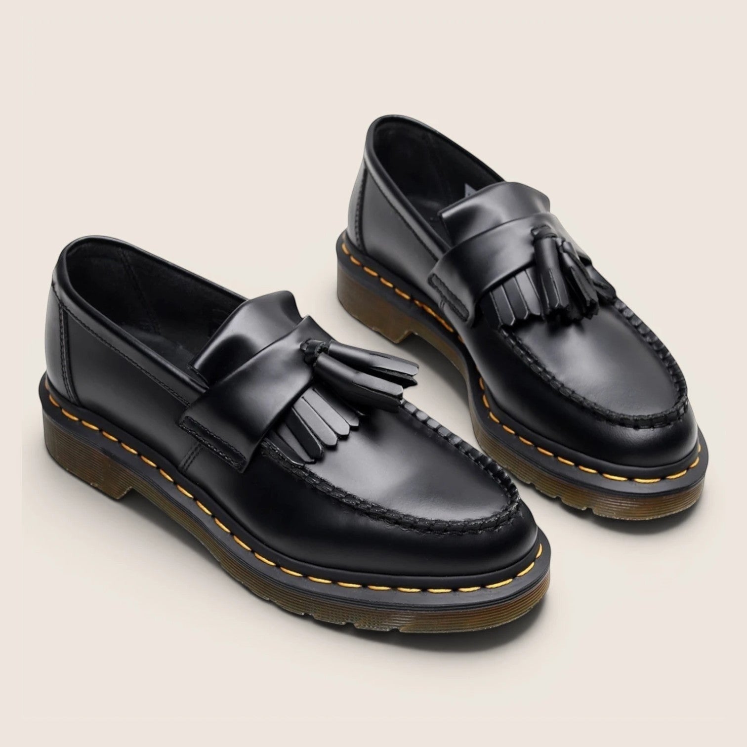 Norielle women's black leather tassel loafers with slip-on design and classic British-inspired silhouette.