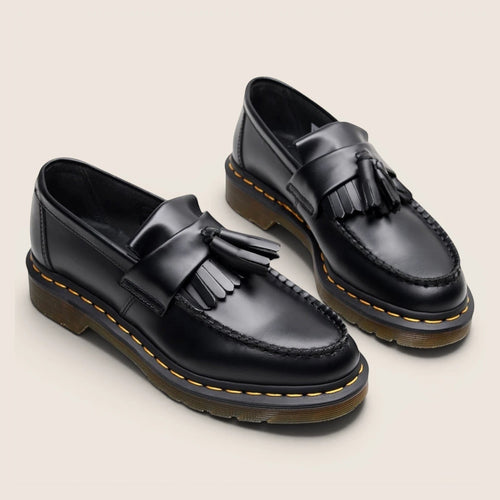 Norielle women's black leather tassel loafers with slip-on design and classic British-inspired silhouette.