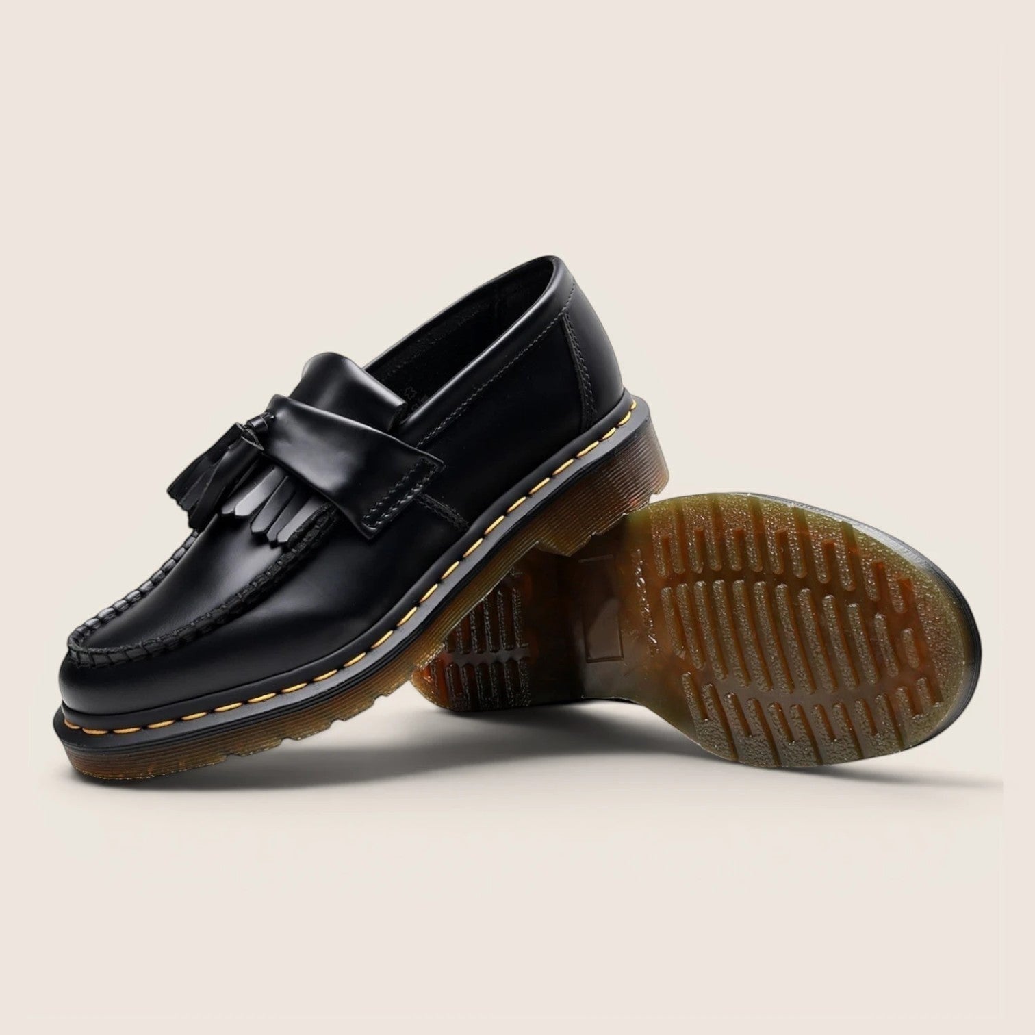 Norielle black leather tassel loafers with slip-on design and classic British silhouette.