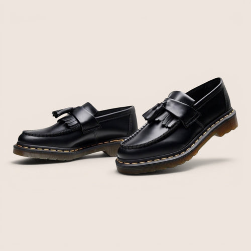 Norielle women's black leather tassel loafers with slip-on design and classic British silhouette.