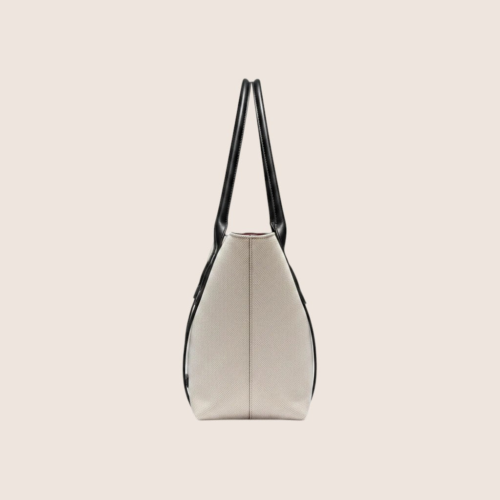 Norielle beige canvas shoulder bag with black leather straps and trim, soft material, double straps.