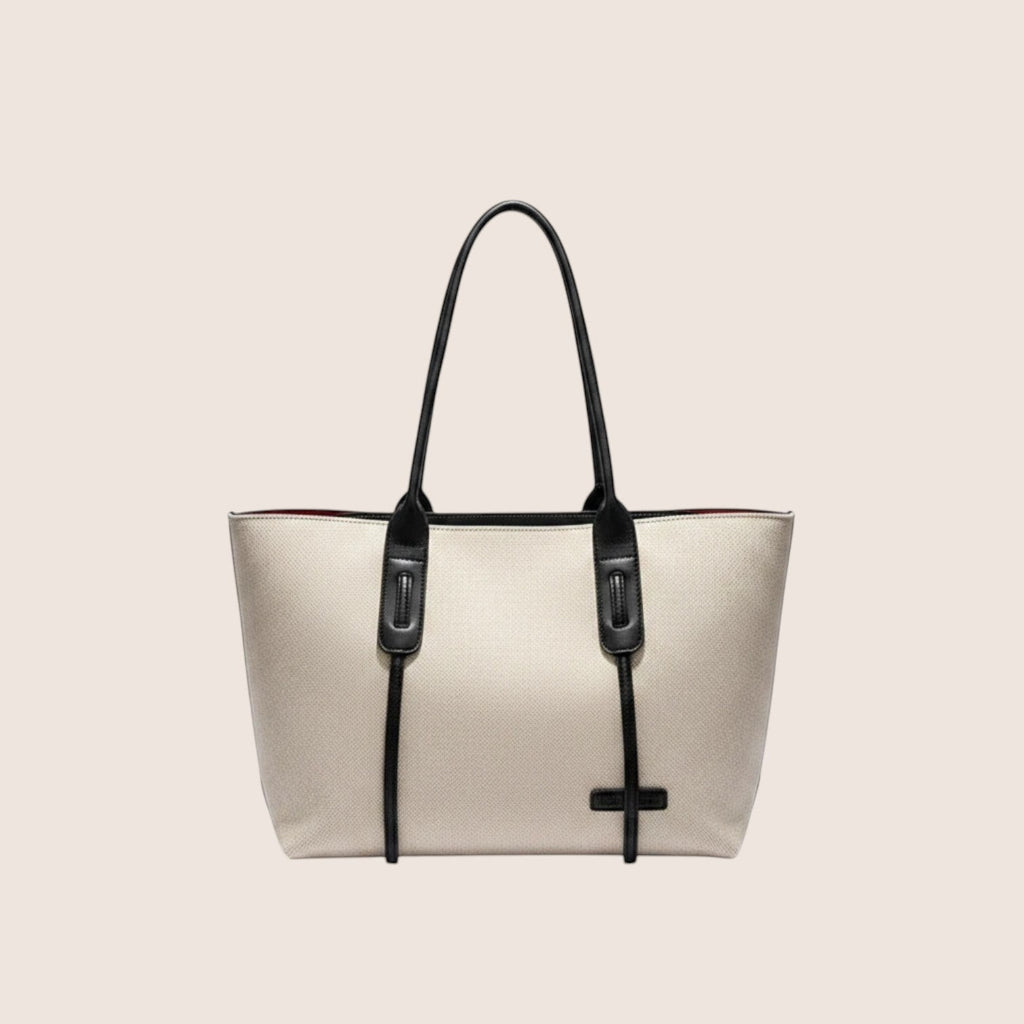 Norielle beige canvas tote bag with black leather trim and handles. Casual, all-match style.