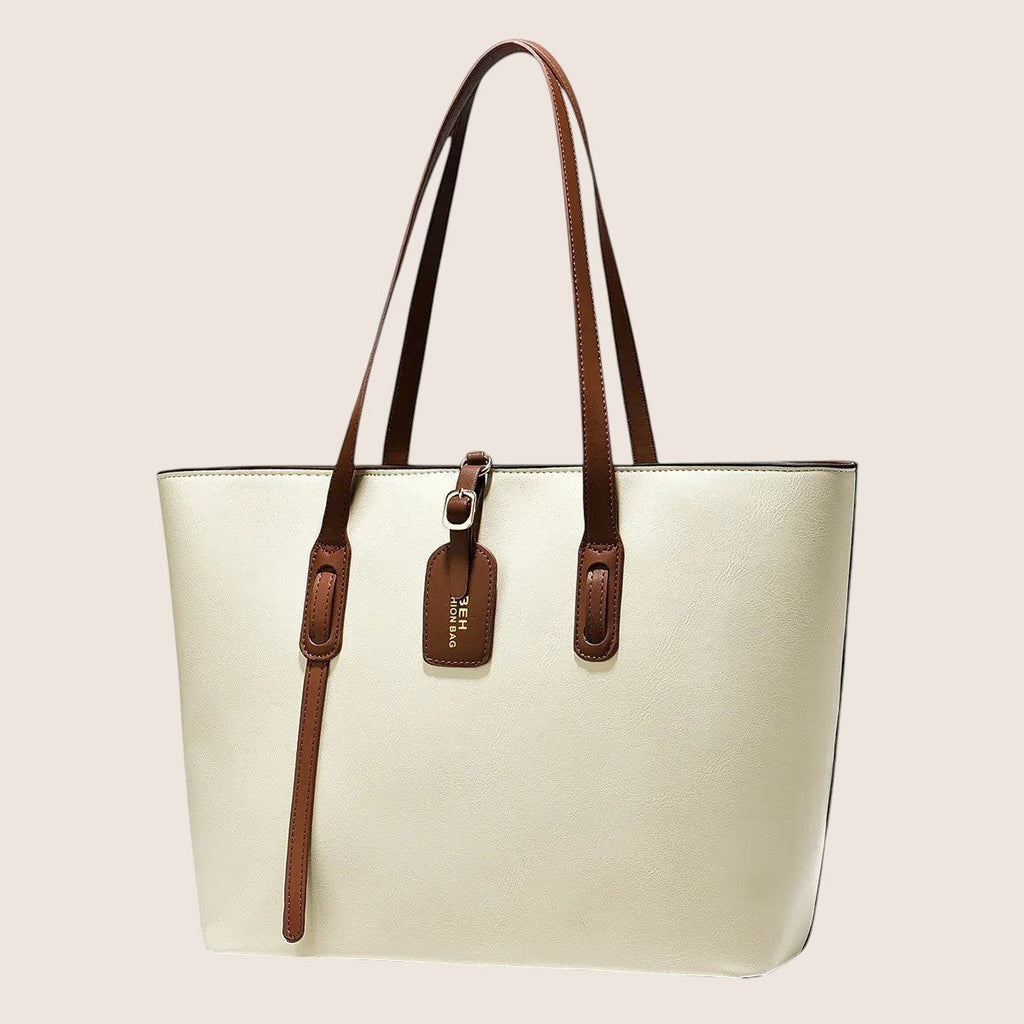 Norielle cream PU leather bucket shoulder bag with brown trim and strap detail. Versatile handbag for daily use.