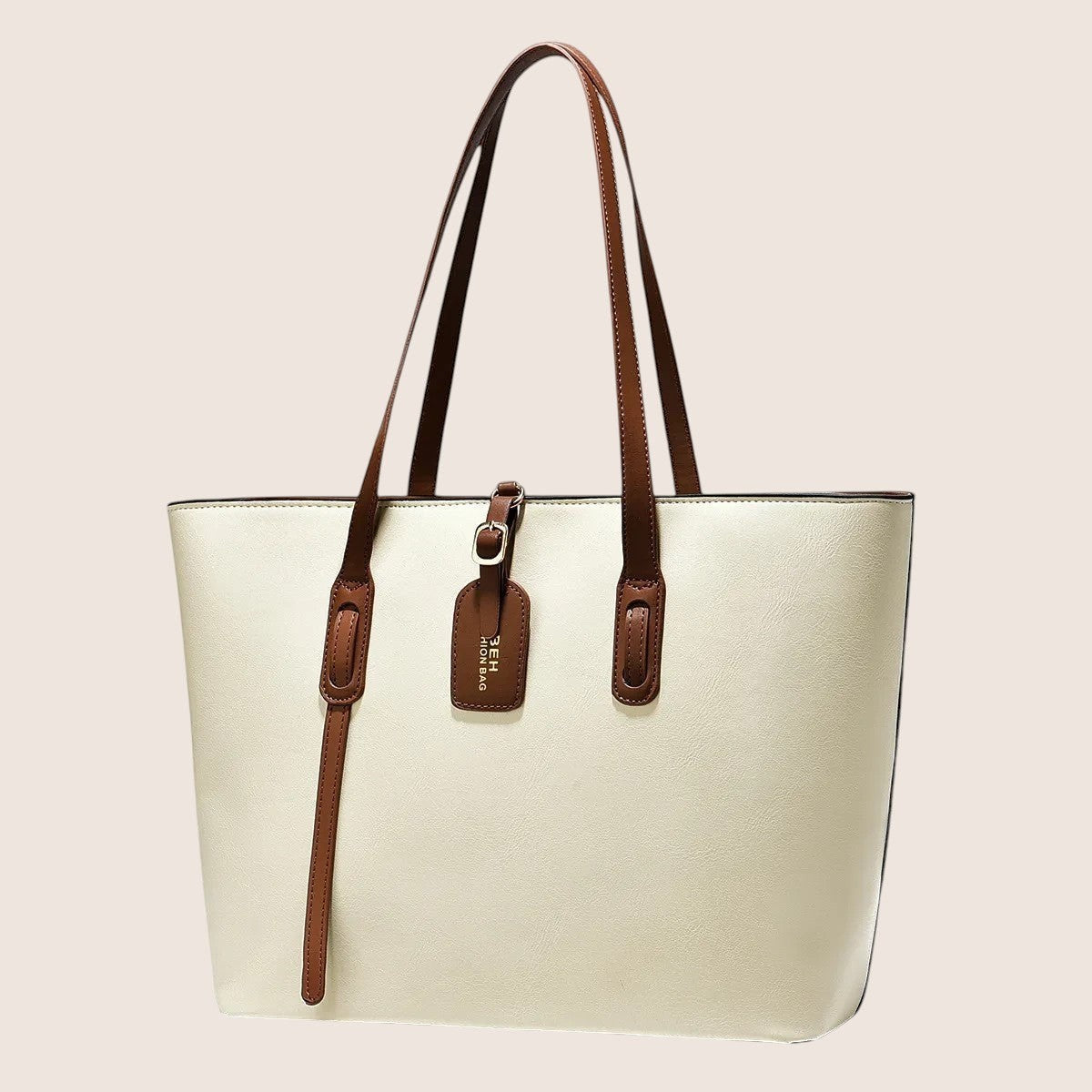 Norielle cream PU leather bucket shoulder bag with brown trim and strap detail. Versatile handbag for daily use.