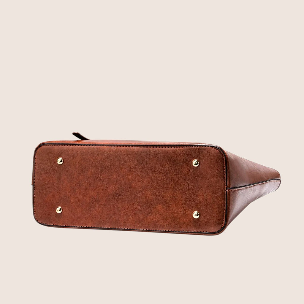 Norielle dark coffee PU leather bucket shoulder bag with medium hardness and multiple interior pockets.